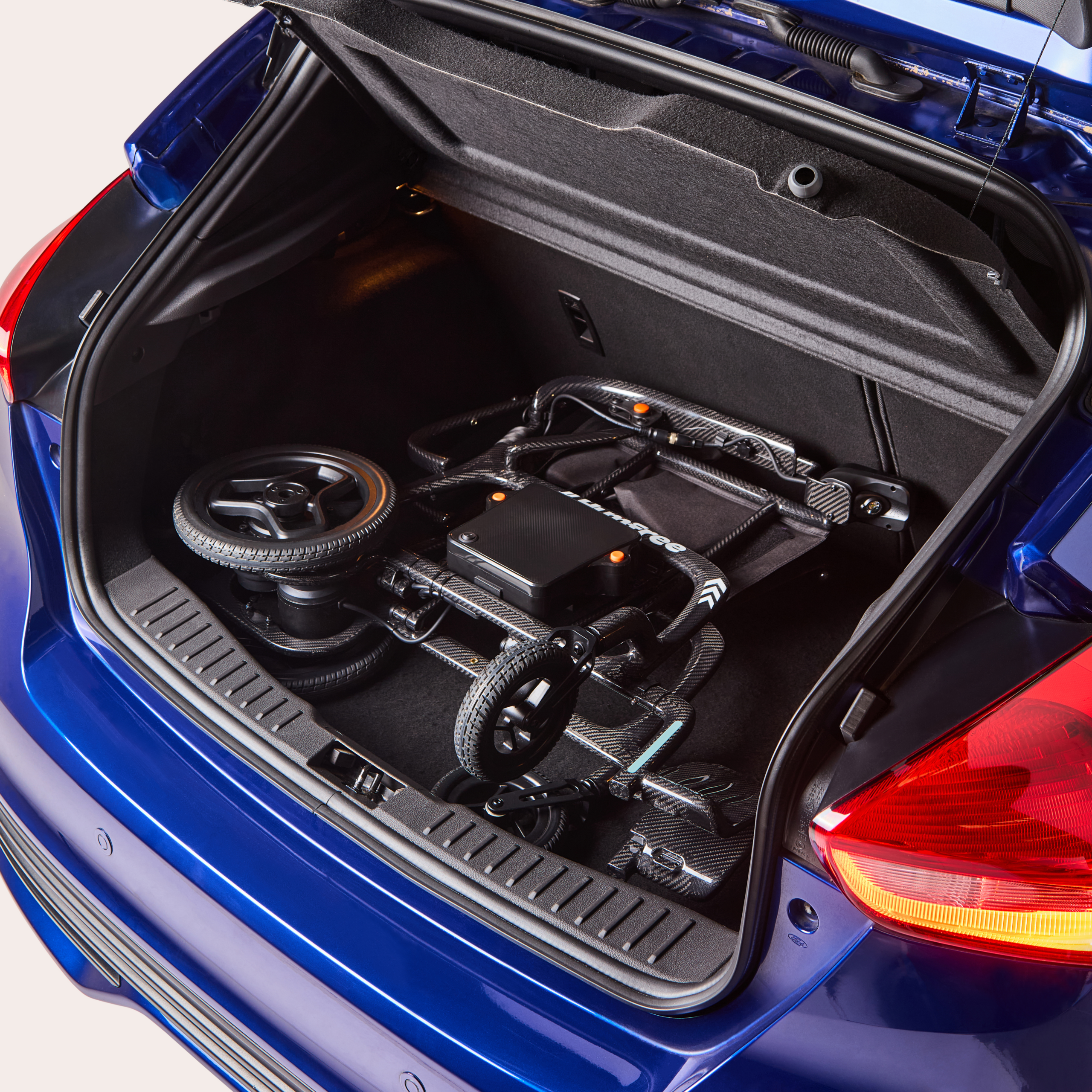 Charcoal Humfree glide powerchair in open car boot