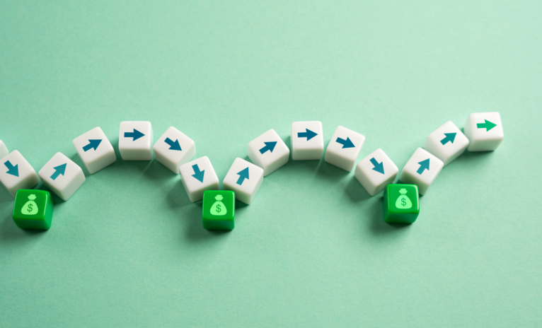 White cubes with arrows curving into green cubes with money icons to signify monthly payments